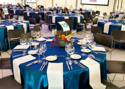 blue linens on round tables for corporate event