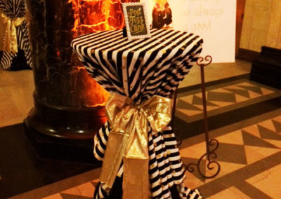 Striped cocktail table tied with gold metallic bow