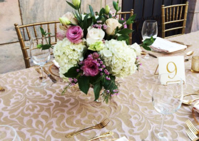 Pink specialty linens with gold flatware for wedding reception