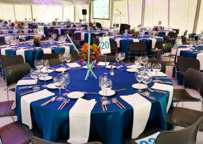 blue linens on round tables for corporate event