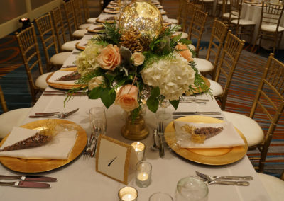 Flower centerpiece on banquet table with gold chivari chairs