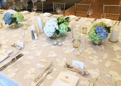 Neutral specialty linen on banquet table with gold chivari chairs